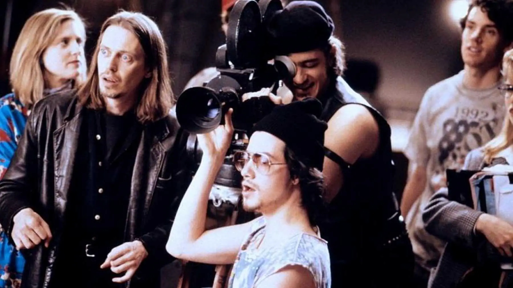 Wanda, Nick, the Assistant Cameraman, and Wolf stand around the camera, shooting a scene