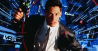 Keanu Reeves holding a gun in the cyberspace world of Johnny Mnemonic