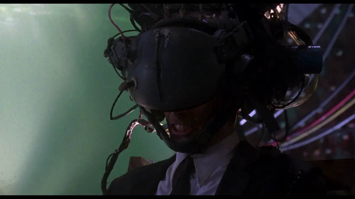 Johnny wears a virtual-reality helmet to try to download his brain data in the climax of Johnny Mnemonic