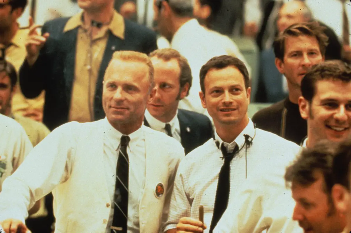 Flight director Gene Kranz standing next to fourth crew member Ken Mattingly in a crowd of other workers