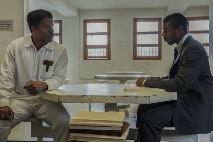 Walter McMillian looks skeptically at attorney Bryan Stevenson in a prison visitation room.