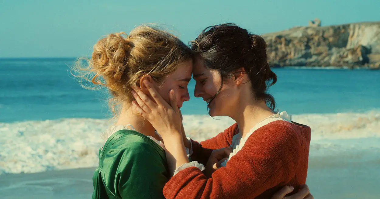 Marianne and Heloise holding each other in embrace on a beach 