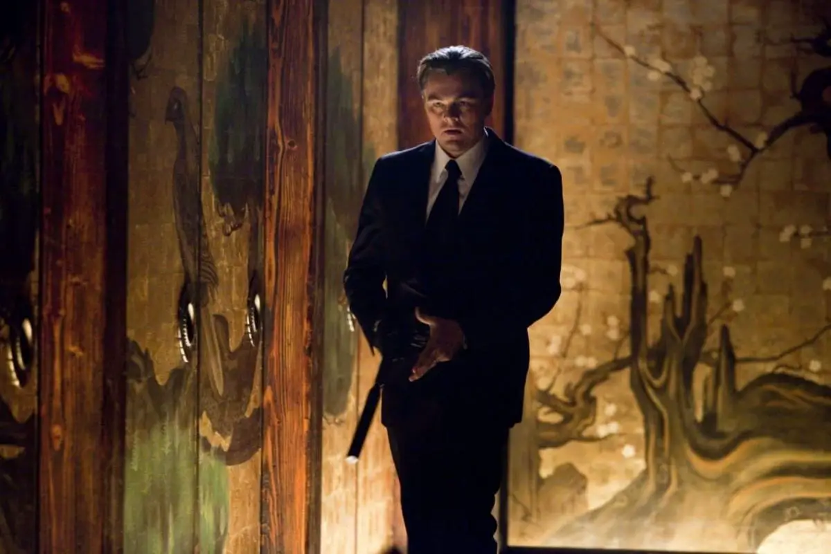 Leonardo DiCaprio in suit with gun in Inception