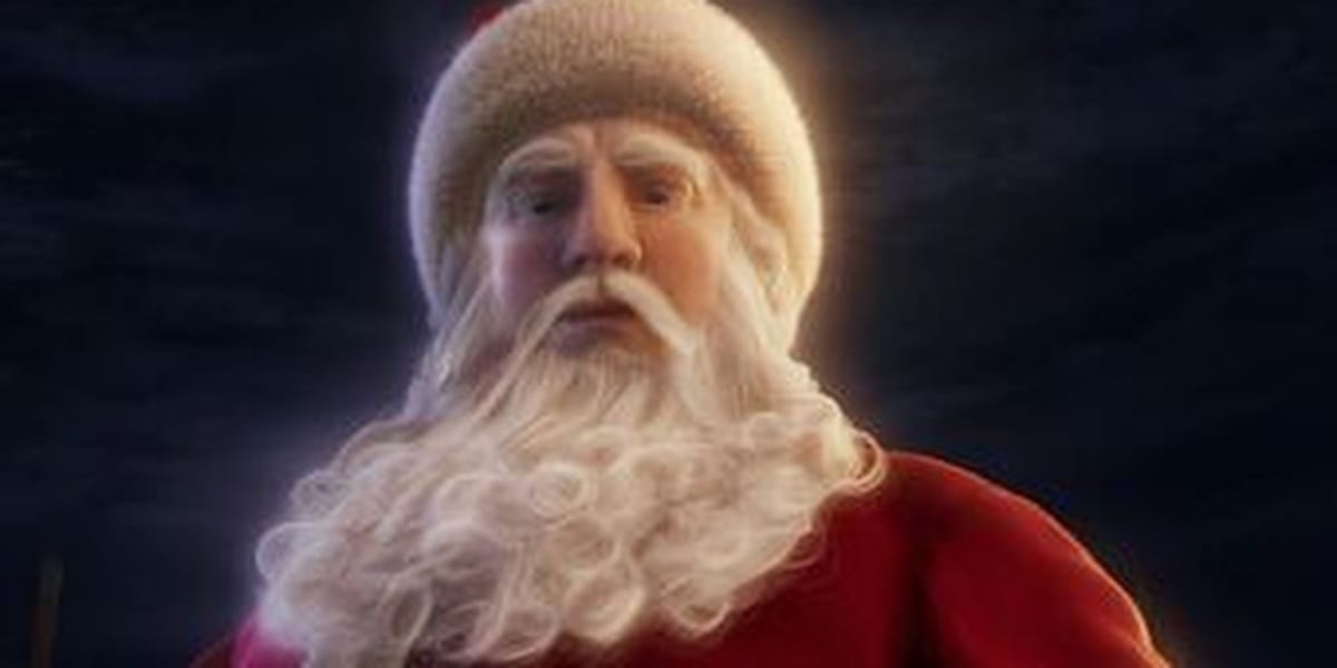 Santa Looking Directly Down, white beard and some of his red suit visible, with a glow around him and a dark background