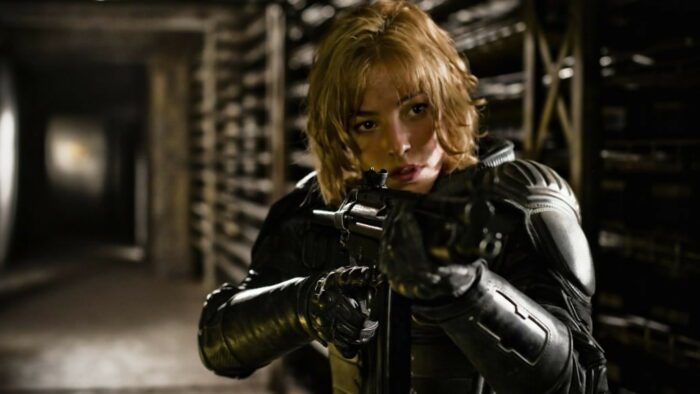 Judge Anderson holds her gun up in a defensive position inside a hallway