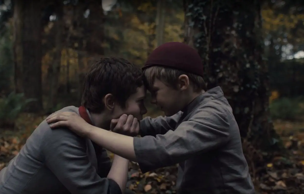 Gretel (Sophia Lillis) and Hansel (Samuel Leakey) press their heads together in an intimate moment