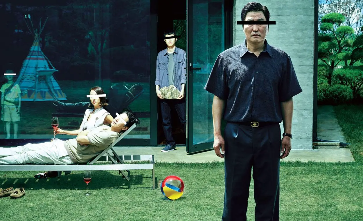 A promotional shot for Parasite, with the four main characters standing or sitting right outside of a house, all with censor bars over their eyes