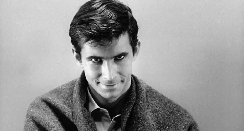 Norman Bates looking at the viewer with a devilish smile