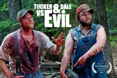 Tucker and Dale standig side by side covered in blood with confused looks on their faces