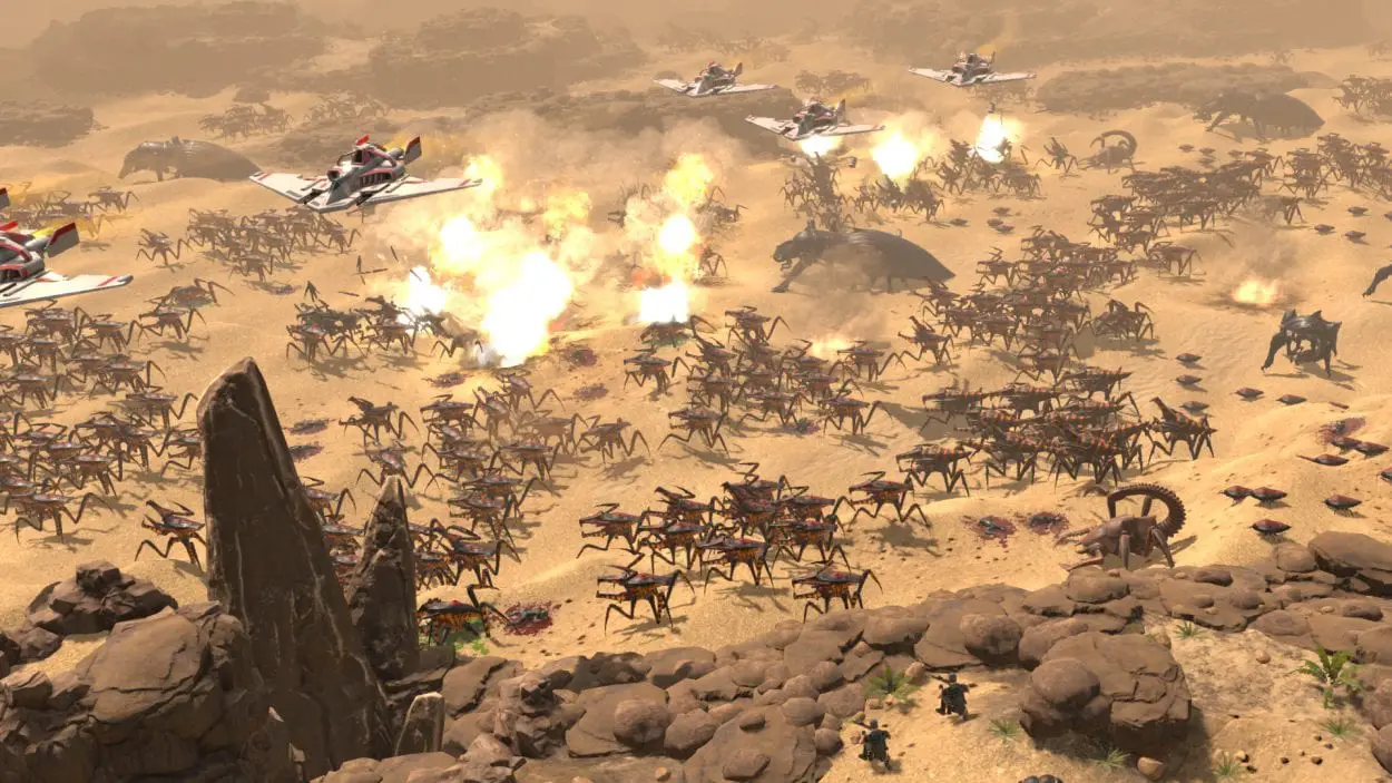 A large battle on an alien world, fighter planes fly above and bomb the insect hordes down below in Starship Troopers