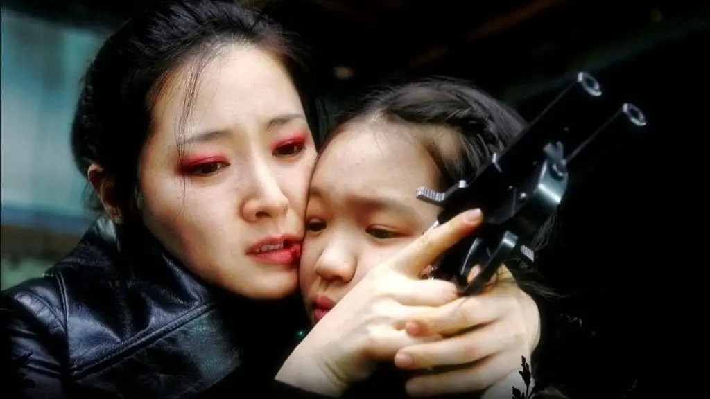 Geum-ja hugs her daughter whilst holding her custom gun