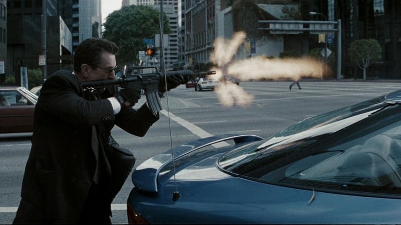 Neil fires a high-powered machine gun at a collection of cops