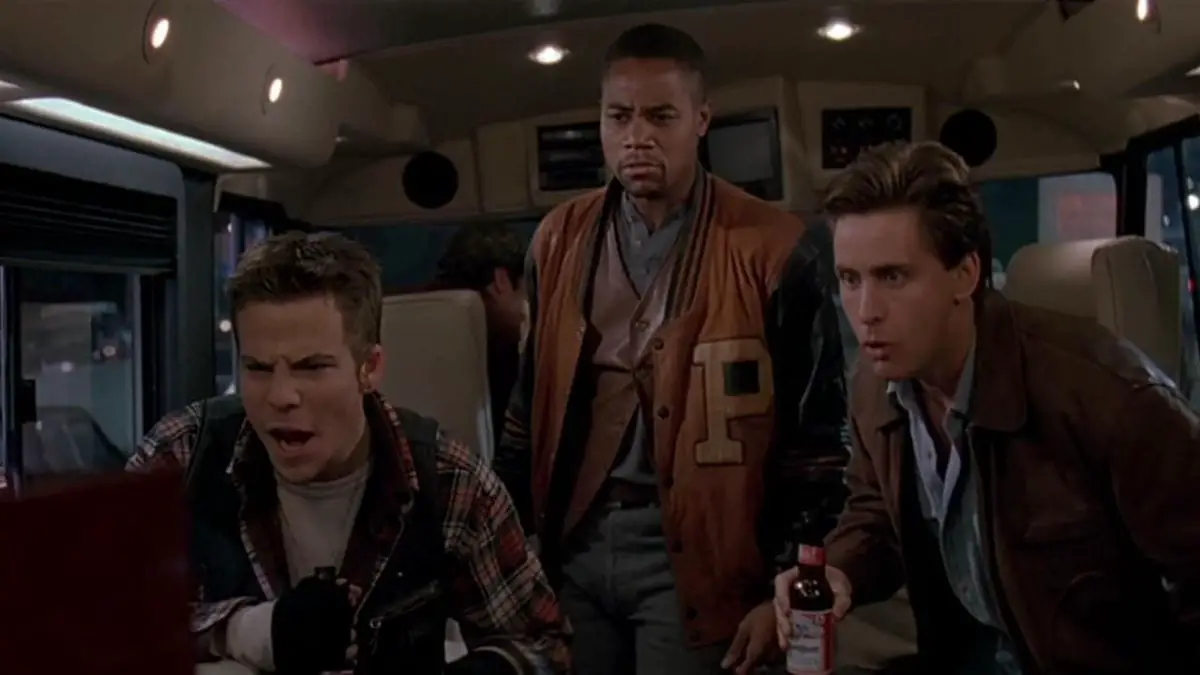 Three friends enjoy a boxing match on the TV in an RV at the start of Judgement Night