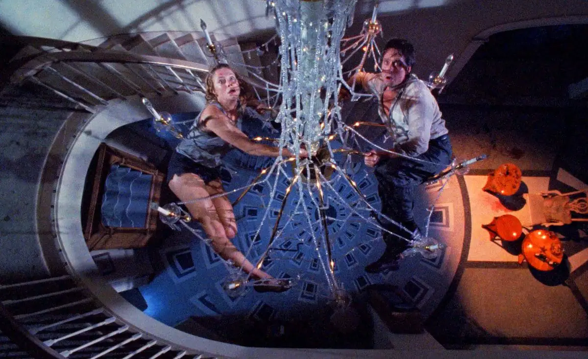 Barbara and Oliver hang dangerously on an insecure chandelier