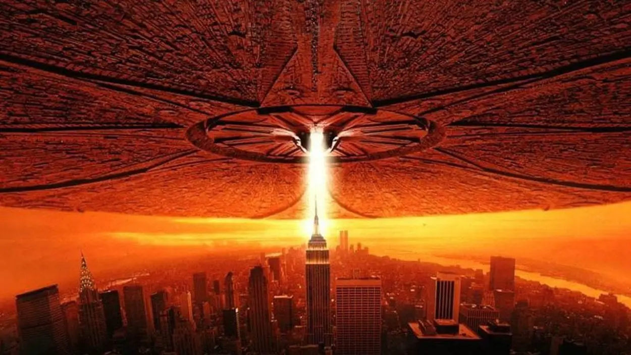 An large alien craft hovering over the Empire State Building with a beam of light coming from it in Independence Day