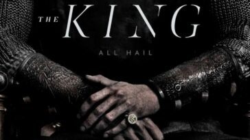A man's arms with hands folded, wearing chain mail armor and gold ring, with text that reads "The King, All Hail."