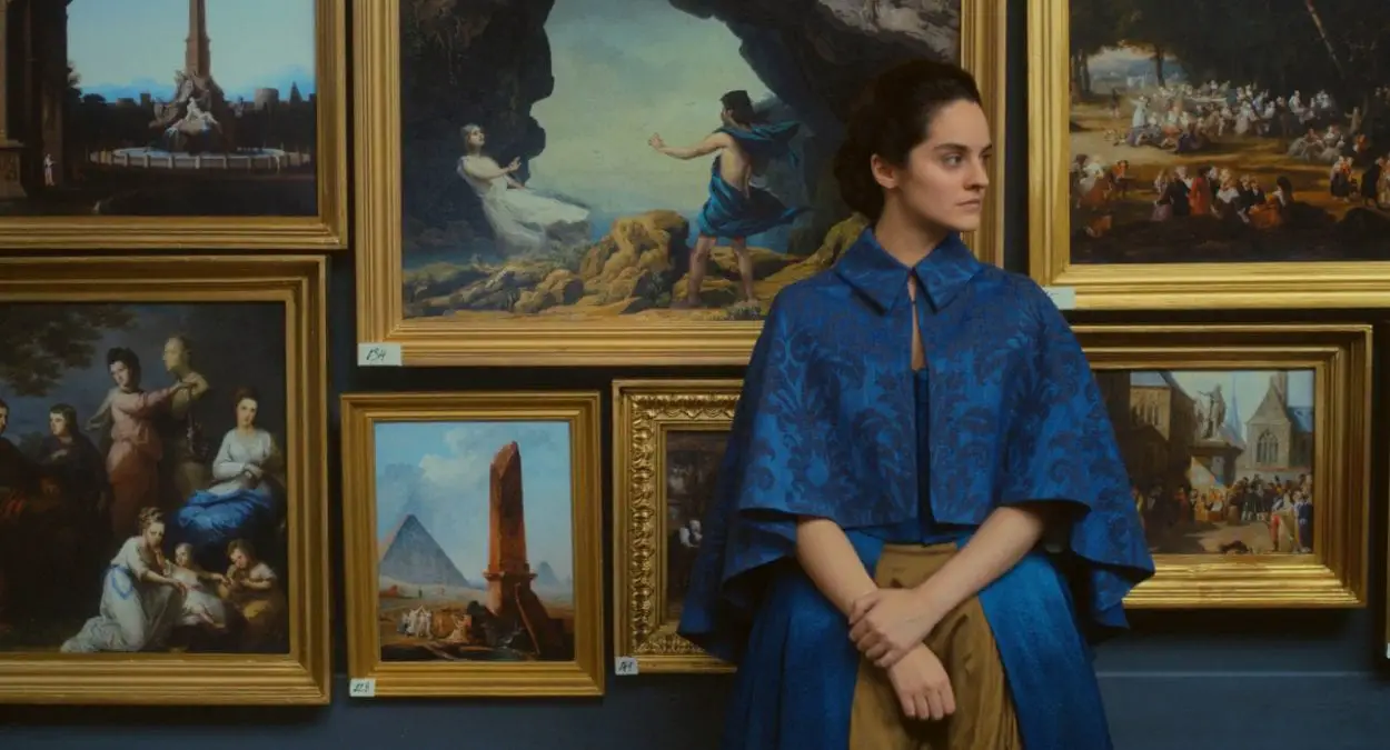 Marianne stands in a museum, with her painting or Orpheus and Eurydice behind her