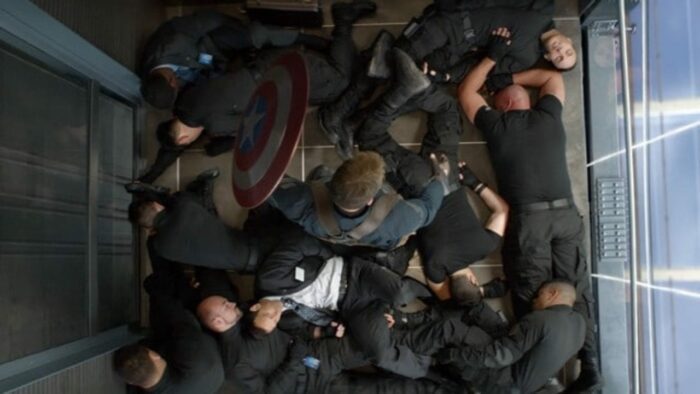 Captain America stands amongst his attackers in an elevator