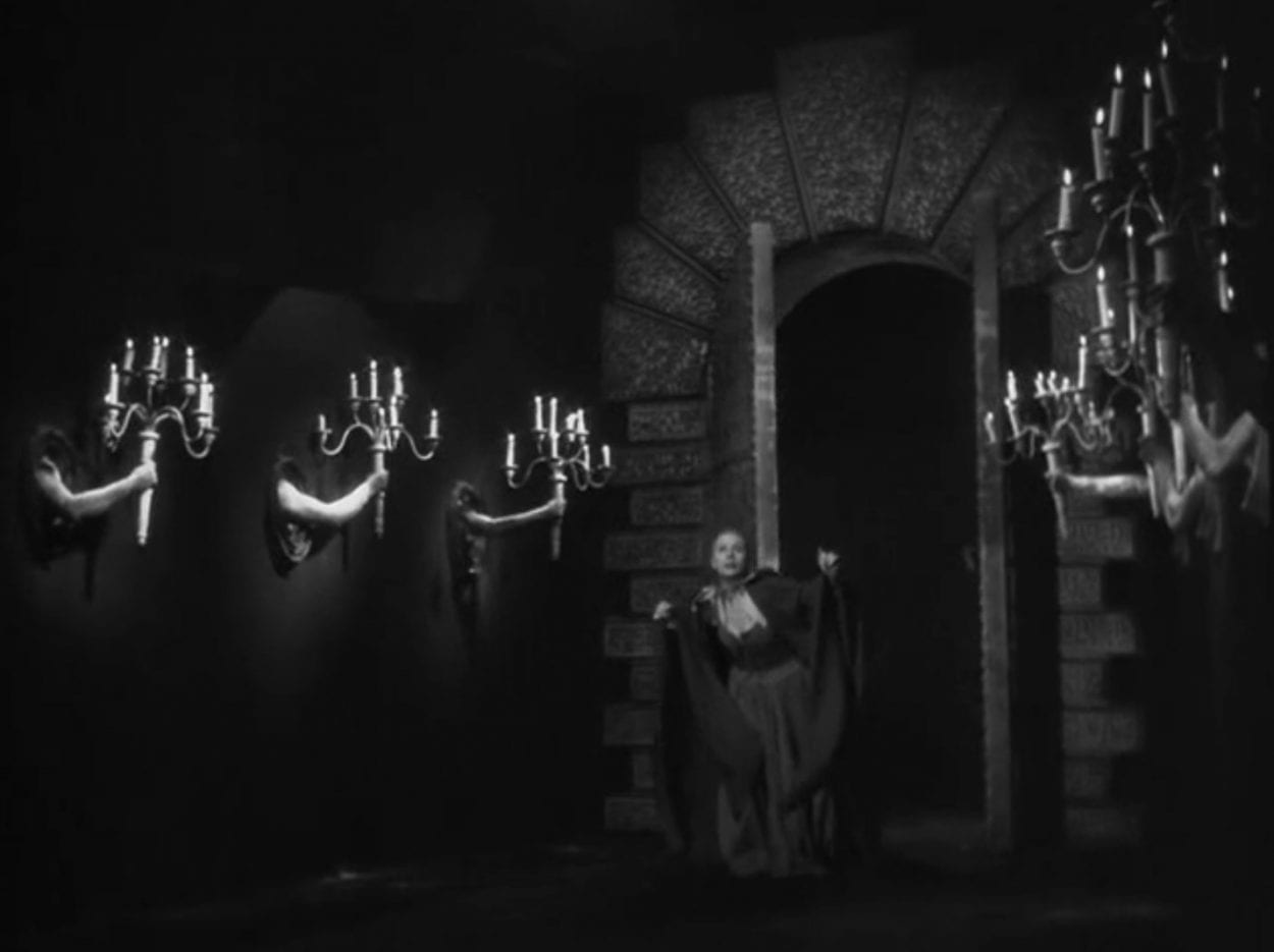Belle in the castle with candelabras held by human hands