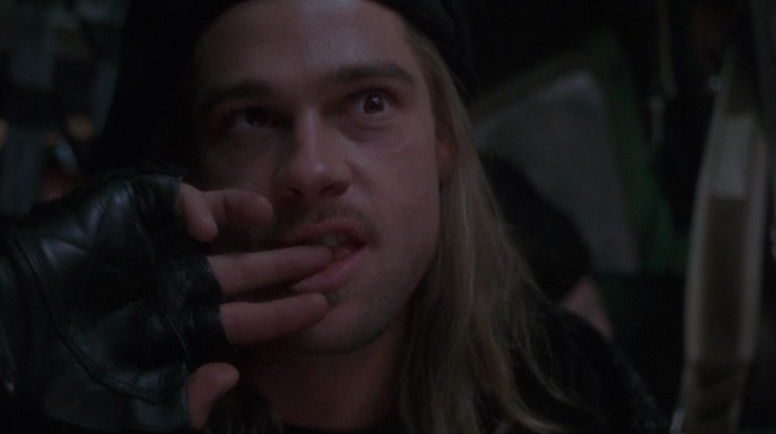 Jeffrey Goines (Brad Pitt) nervously bites his finger