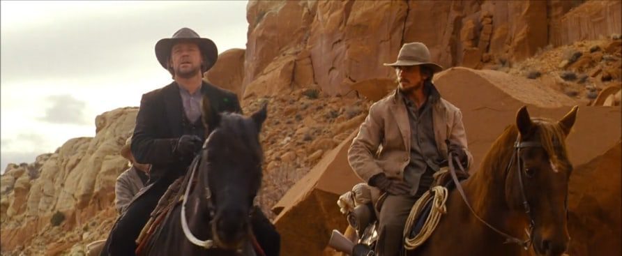 Ben Wade and Dan Stevens sit on horseback in discussion with one another.