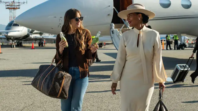 Maggie offers Grace a drink after deboarding her private jet.