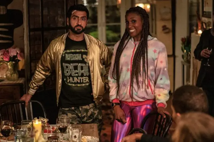 Jibran and Leilani awkwardly arrive at a dinner party in out-of-place clothing.
