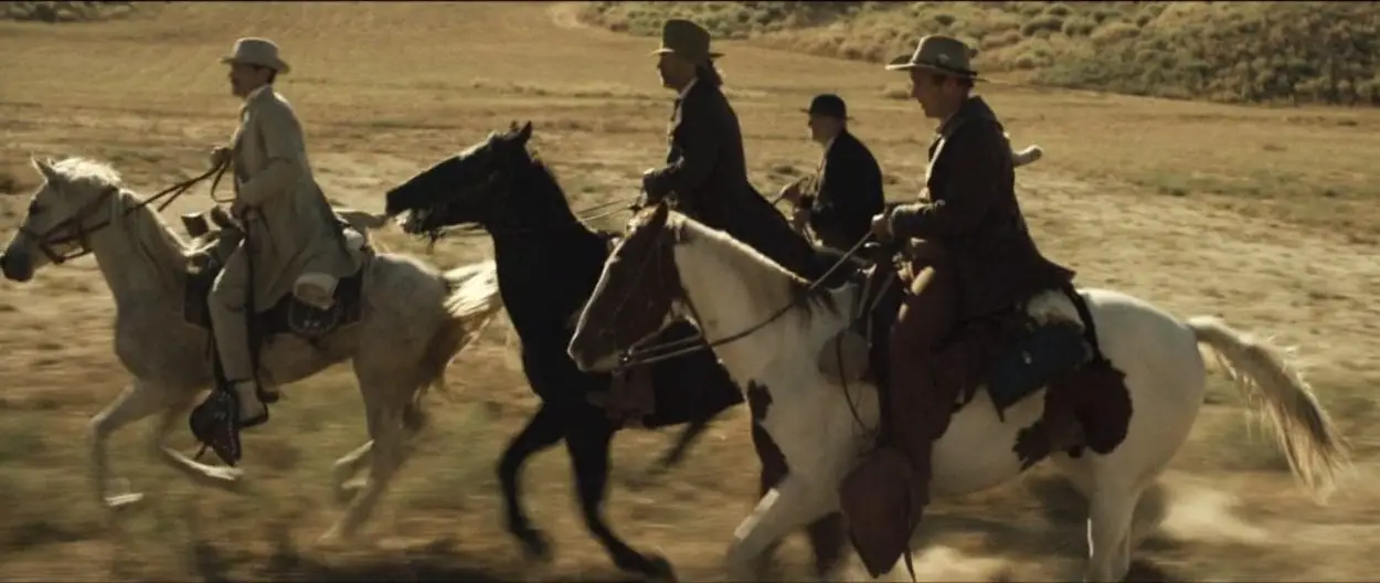 Arthur, Sheriff Hunt, Brooder and Chicory ride side by side across the plains 