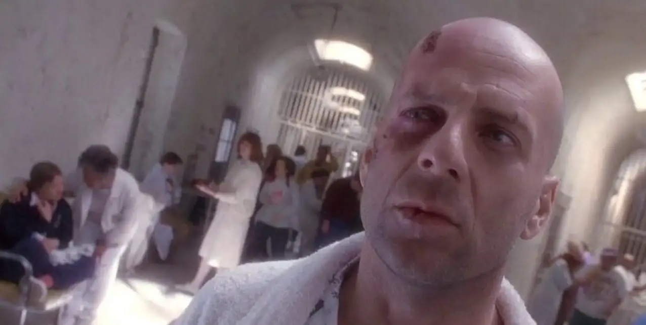 James Cole (Bruce Willis) puzzlingly looks offscreen in a psychiatric hospital