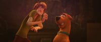 Shaggy and Scooby react in a frightened way to something in front of them