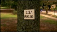A shot of a tree with a sign that says "Idea Missing" in bold letters