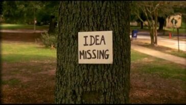 A shot of a tree with a sign that says "Idea Missing" in bold letters