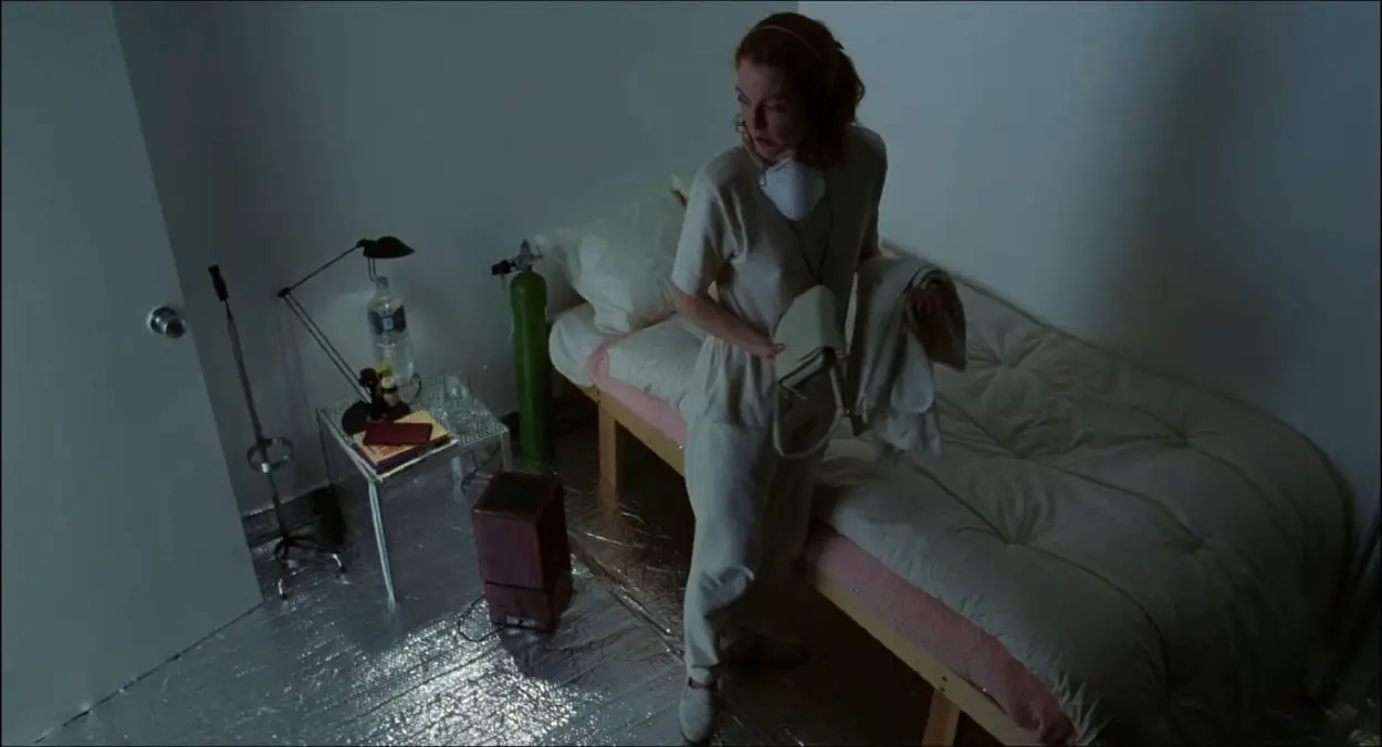 Carol White (Julianne Moore) walks around the inside of a secured and chemical-free room in her house before getting ready to leave