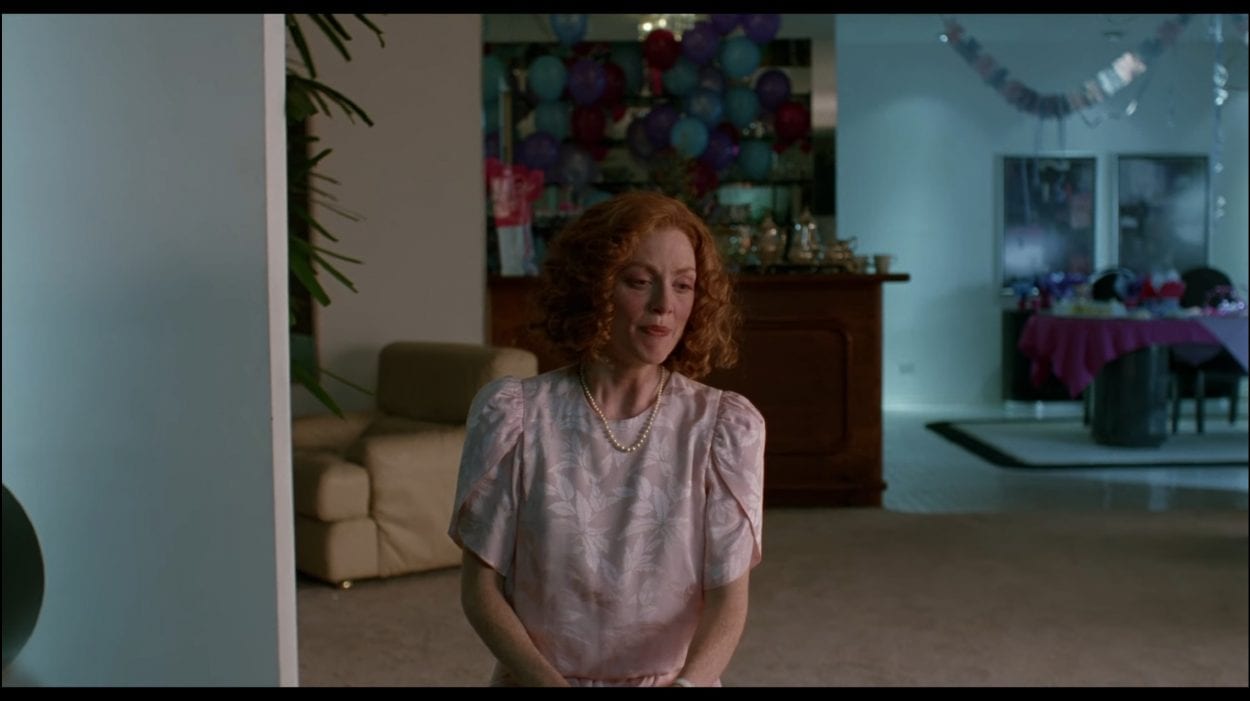 Carol White (Julianne Moore) begins to have an extreme panic attack in the living room of a baby shower.