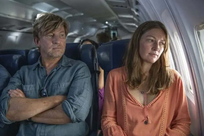 Jim and Georgie share neighboring seats aboard a plane.