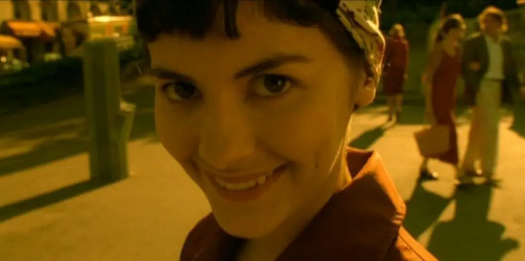 Amelie is in a street, looking at the camera and smiling