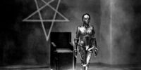 Robot Maria standing in front of a pentagram