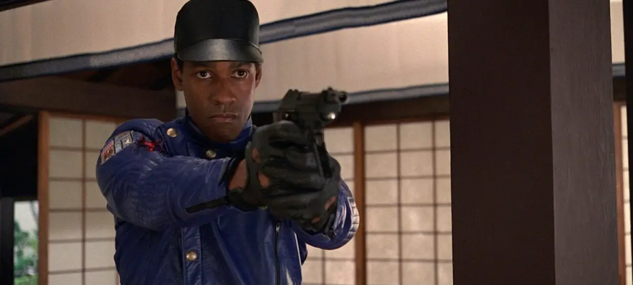 Parker Barnes, in a cop uniform, points a gun.