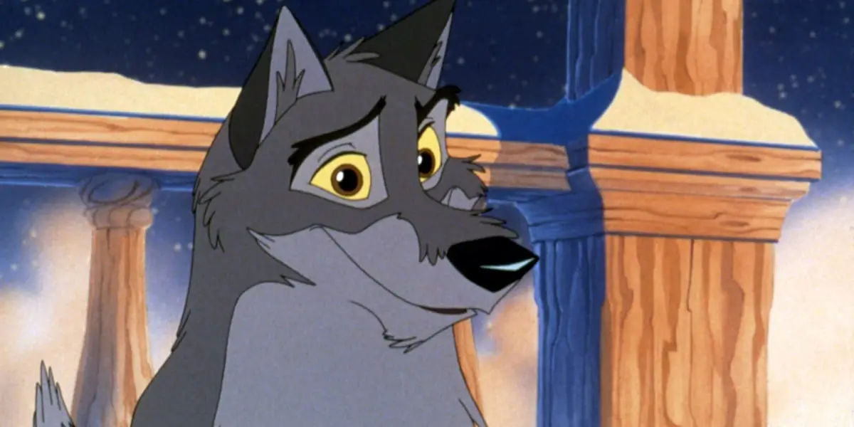 Balto looking ahead, offering a slight smile, as it snows in the background, a railing also visible behind him in 1995 film