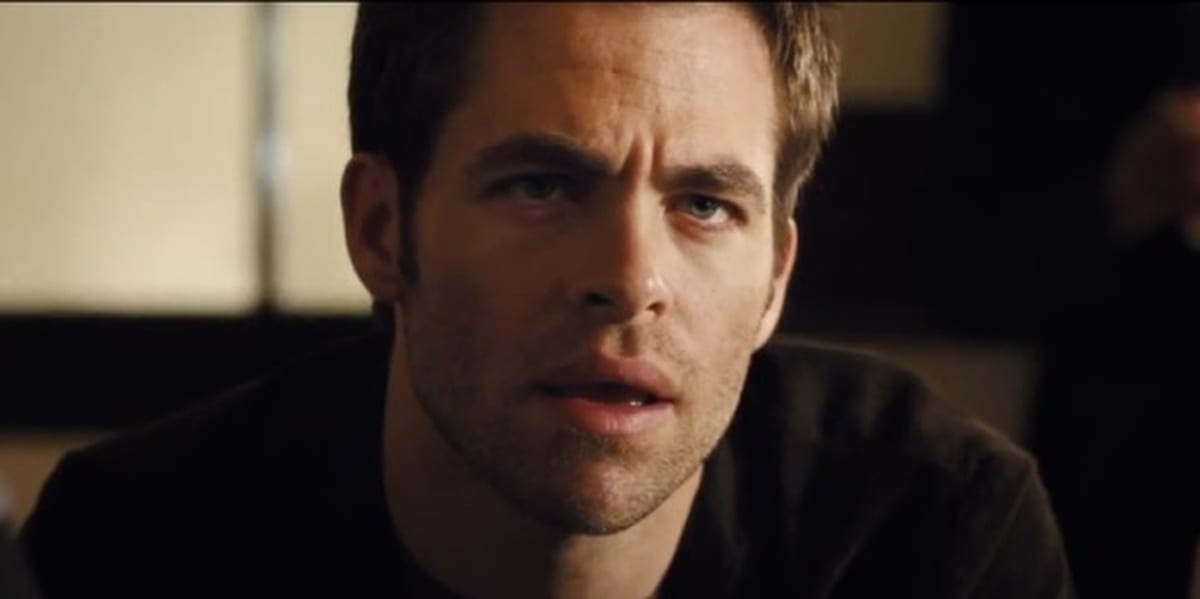 Chris Pine looking ahead and slightly above him in shock, furrowing his eyebrows and his mouth half open in People Like Us