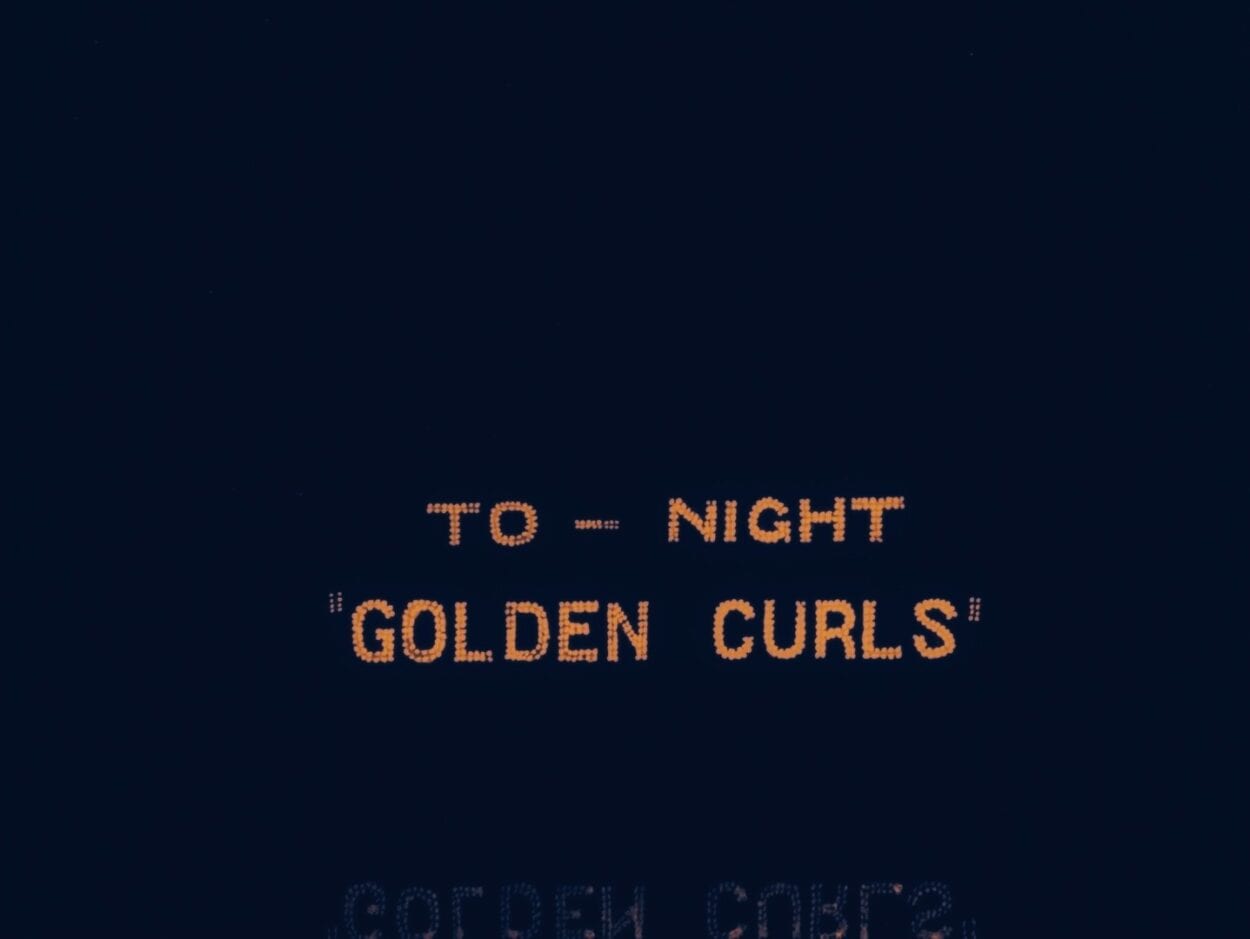 A sign advertises a show: Golden Curls