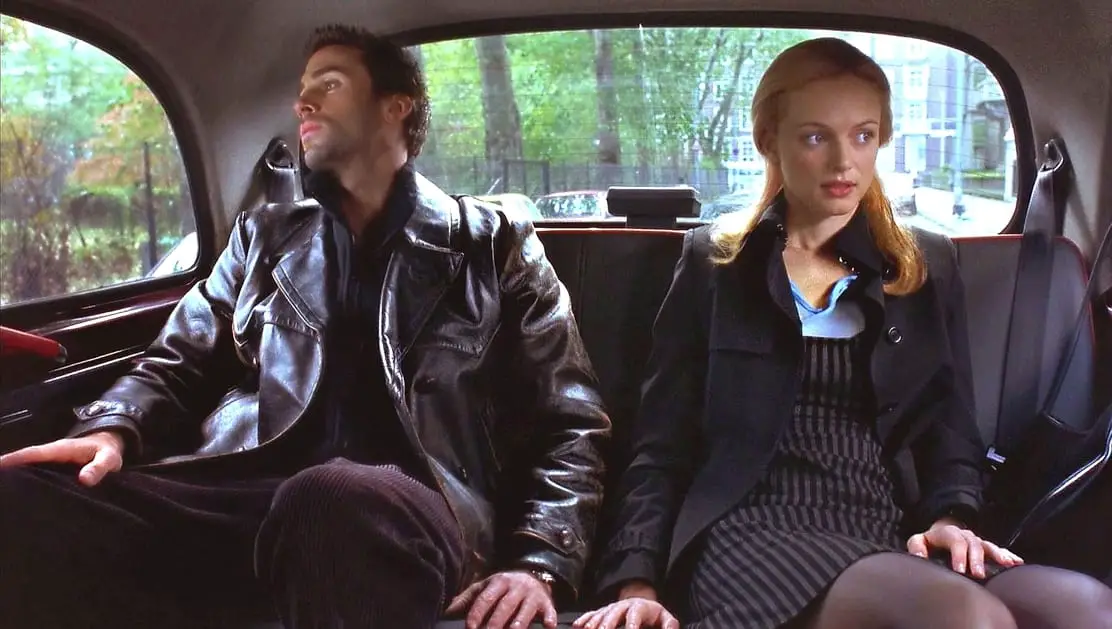 Alice and Adam sit silently in the back of a London taxi