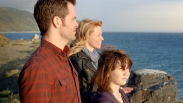 Chris Pine, Elizabeth Banks and Michael Hall D'Addario standing on a cliff and looking out at the water, sun shining on them, in People Like Us