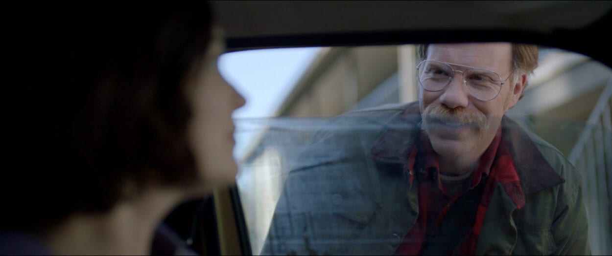 The Man (Marc Menchaca) peering into Jessica's (Jules Wilcox) car.