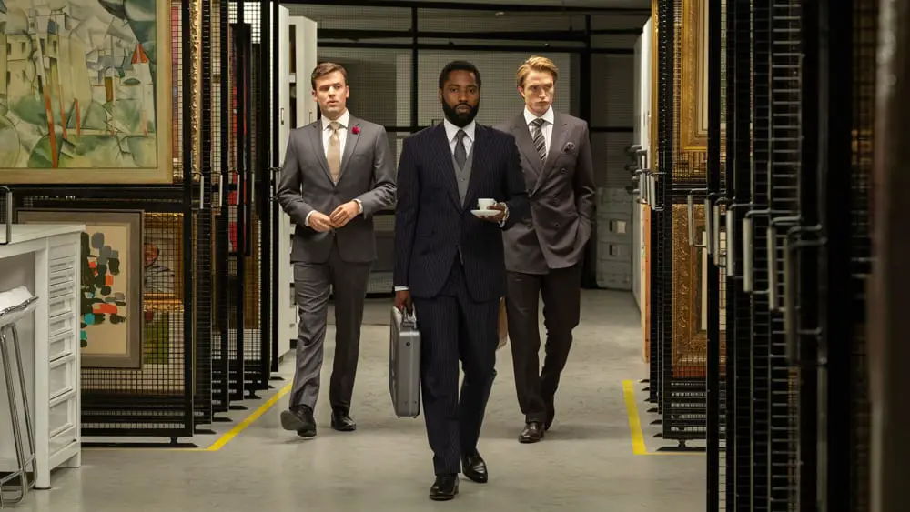 John David Washington and Robert Pattinson are shown through the vaults of a secure facility in Tenet