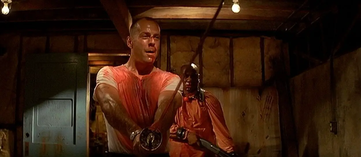 Bloody Bruce Willis holding a samurai sword with Ving Rhames behind him