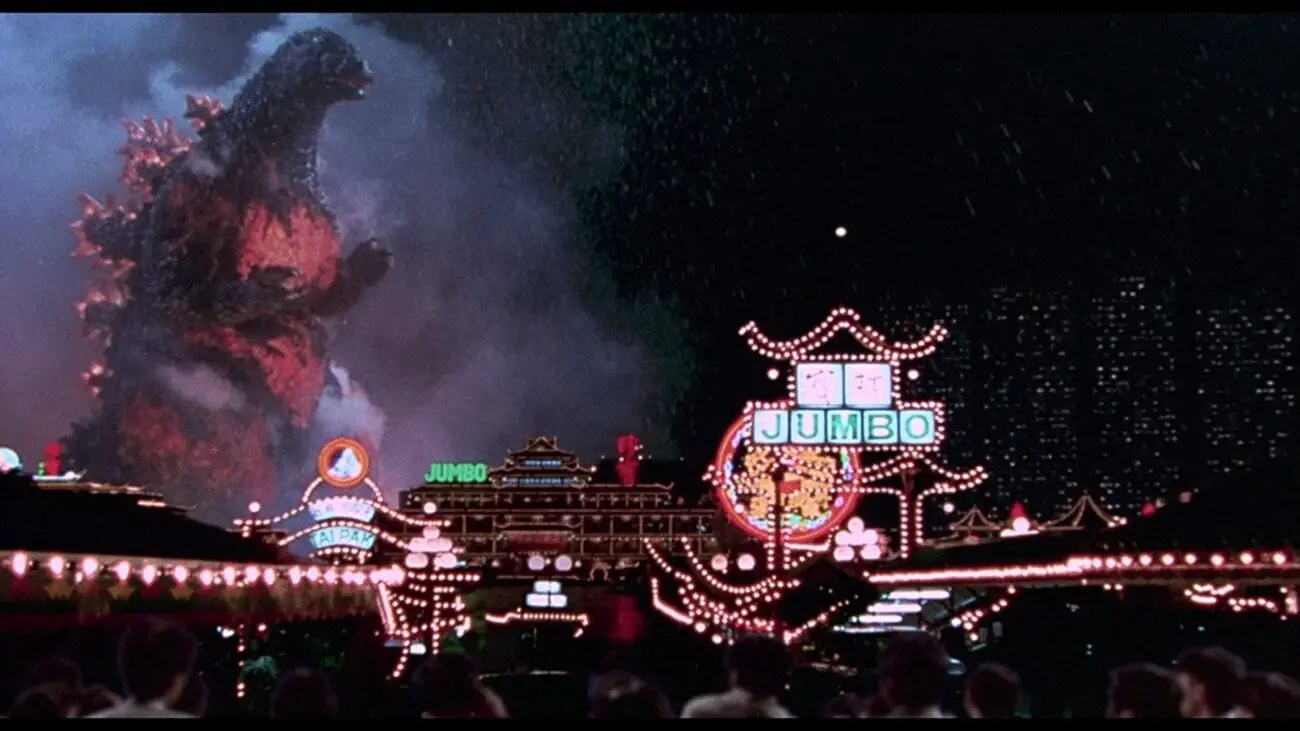 Godzilla stomps through Tokyo's neon buildings, glowing bright orange due to his impending nuclear meltdown.