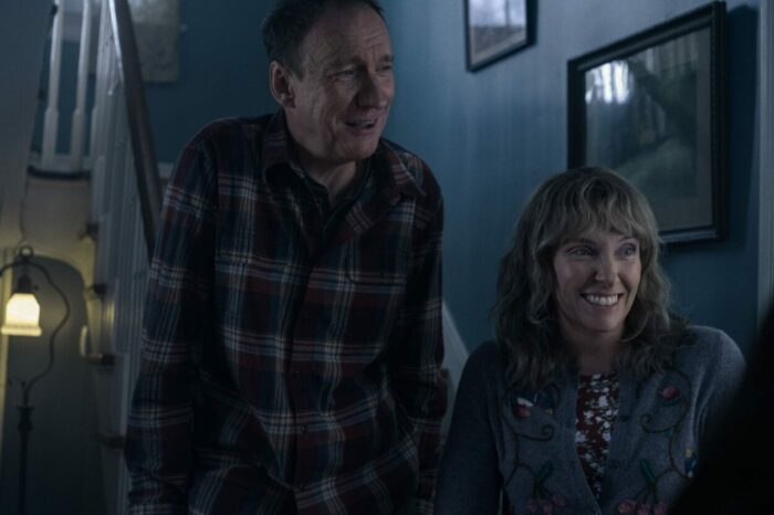 Jake's mother and father smile at meeting his girlfriend.