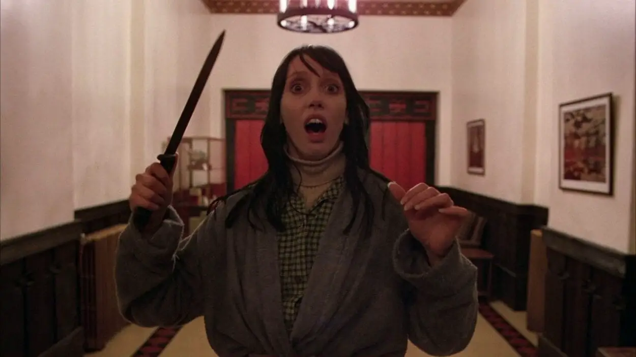 Shelley Duvall as Wendy in Stanley Kubrick's The Shining: she is brandishing a knife