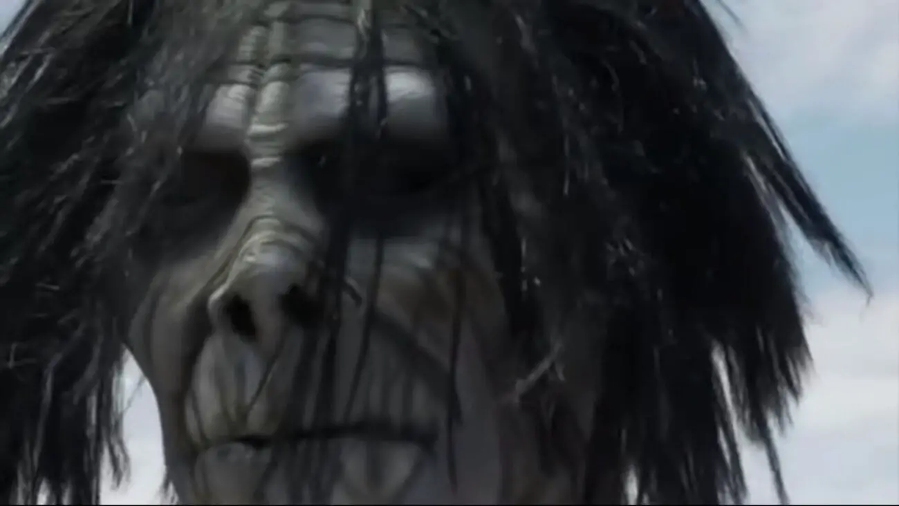Neil Breen as "The Being" from I Am Here....Now. Extreme closeup of what appears to be a white zombie or monster mask with wild unkempt hair.